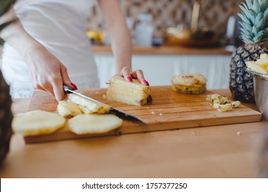 Pineapple Sliced By A Girl On The Kitchen Counter. Pineapples Contain A Group Of Digestive Enzymes As Bromelain, Function As Proteases, Break Down Protein Molecules Into Amino Acids And Small Peptides