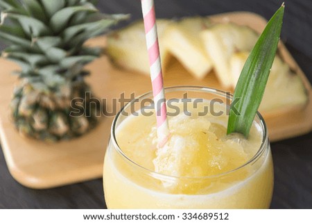 pineapple smoothie on wood background