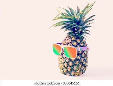 pineapple in a sunglasses on white background