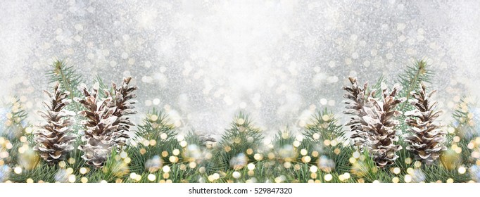 Pinecones and fir tree on sparkling background. Christmas decoration background