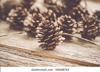 Pinecones on Rustic Wood Background