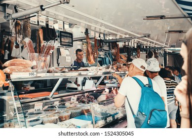 Pineda De Mar, Barcelona, Spain - August, 16, 2019: Sale Of Meat Products - Jamon, Ham And Sausages At A Street Fair. Big Tent And Shoppers