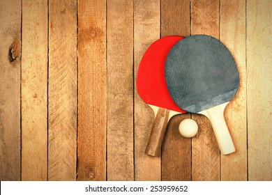 Ping Pong Paddles And Ball On Wooden Texture With Copyspace