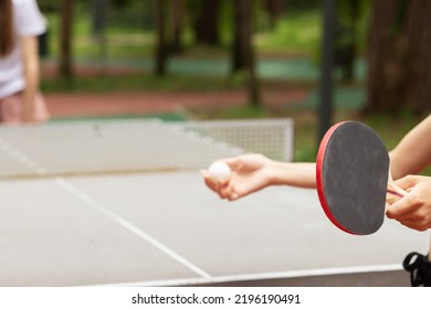 ping pong in park, two girls teenagers play table tennis, sports and outdoor recreation, active leisure in the summer for teens