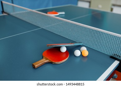 Ping Pong Rackets And Balls On Game Table With Net