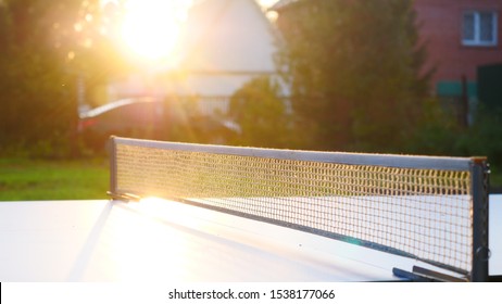 Ping pong table and net closeup in sunset light. Shadow - Powered by Shutterstock