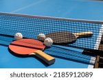 Ping pong table, rackets and balls in a sport hall.