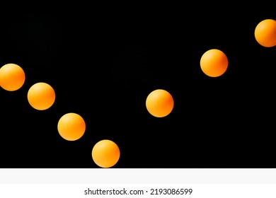 Pingpong Ball In Flight Orange On Black Background