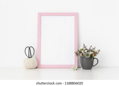 Pink A4 Portrait Frame Mockup With Dried Field Wild Flowers In Gray Mug And Vintage Scissors On White Wall Background. Empty Frame, Poster Mock Up For Presentation Design. Template Frame For Text