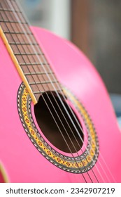 A pink acoustic guitar close-up