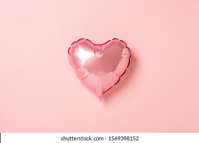 Pink air balloon heart shape on a pink background. Wedding concept, Valentine's Day, a gift for a loved one. Banner. Flat lay, top view