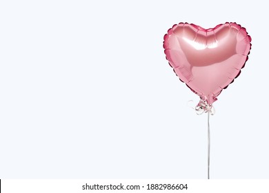 Pink air balloons heart shape on a white background. Concept wedding, valentines day, photo zone, lovers. Banner. Flat lay, top view