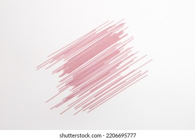 Pink Angel Hair Pasta Lay Down On Top Of White Backrground