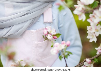Pink apple flower in pink cloth pocket. Summertime or springtime, romantic concept. Minimal trendy composition in pastel colors. Close up.