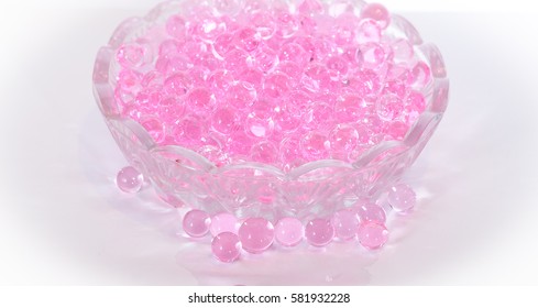 Pink aroma beads in a small glass dish