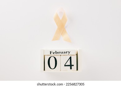 Pink awareness ribbon sign and Calender 4 February of World Cancer Day campaign isolated on white background with copy space, concept of medical and health care support - Shutterstock ID 2256827305