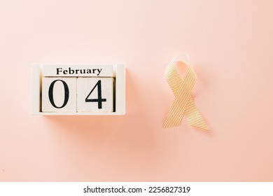Pink awareness ribbon sign and Calender 4 February of World Cancer Day campaign on pastel pink background with copy space, concept of medical and health care support - Shutterstock ID 2256827319