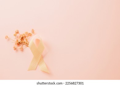 Pink awareness ribbon sign and paper card flower of World Cancer Day on pink background with copy space, concept of medical and health care support, Breast cancer awareness concept, 4 February - Shutterstock ID 2256827301