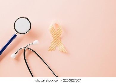 Pink awareness ribbon sign and stethoscope of International World Cancer Day campaign month on pastel pink background with copy space, concept of medical and health care support, 4 February - Shutterstock ID 2256827307