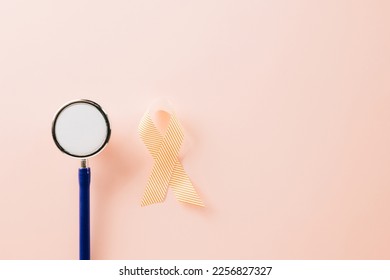 Pink awareness ribbon sign and stethoscope of International World Cancer Day campaign month on pastel pink background with copy space, concept of medical and health care support, 4 February - Shutterstock ID 2256827327