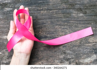 Pink awareness ribbon symbolic bow color raising support campaign on people living life with tumor Breast cancer - Shutterstock ID 340264271