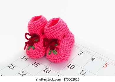 Pink Baby Booties On A Calendar Background, Baby Due Date