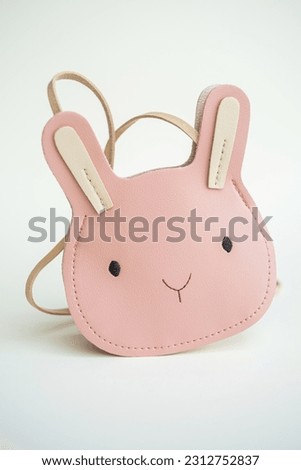 Pink baby handbag. Pink rabbit handbag for girls on a white background. Isolated on a white background, a pink children's handbag.
