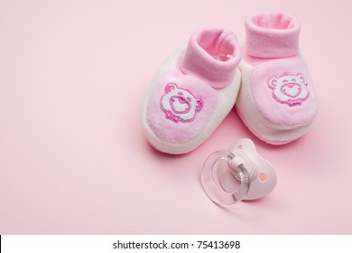 the pink baby shoes and pacifier