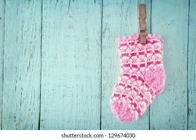 Pink baby socks on a blue wooden rustic background with copy space - Powered by Shutterstock