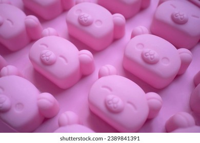 pink background with pattern of bears with expressive faces