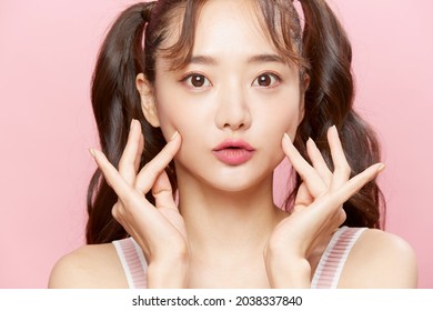 Pink Background Portrait Of A Young Asian Woman With Pigtails