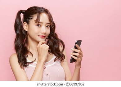 Pink Background Portrait Of A Young Asian Woman With Pigtails