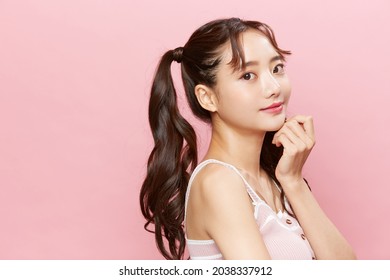 Pink Background Portrait Of A Young Asian Woman With Pigtails