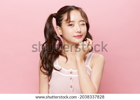 Pink background portrait of a young Asian woman with pigtails Foto d'archivio © 