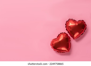 Pink background with red hearts balloons. Valentine's day concept