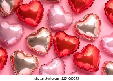 Pink background with red hearts balloons. Valentine's day concept