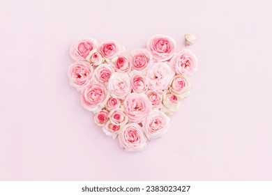 Pink background with roses, macro flowers, holiday concept. Greeting card for Mother's Day, March 8, Women's Day, wedding, birthday, Valentine's Day. Selective focus. Нeart with flowers. Greeting card