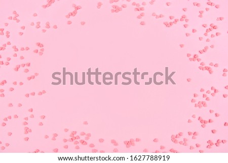 Pink background with tiny hearts. Valentine's day concept. Top view.