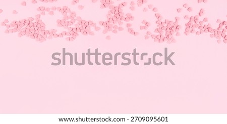 Pink background with tiny hearts. Valentine's day concept. Top view.