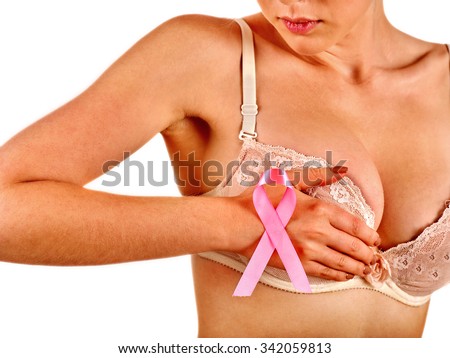 Pink badge on woman hand cover breast  to support breast cancer cause. Social awareness symbol.