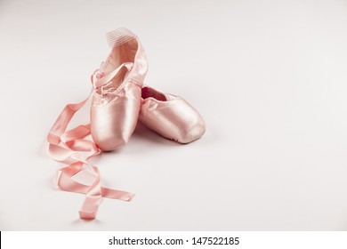 Pink Ballet shoes on white background.