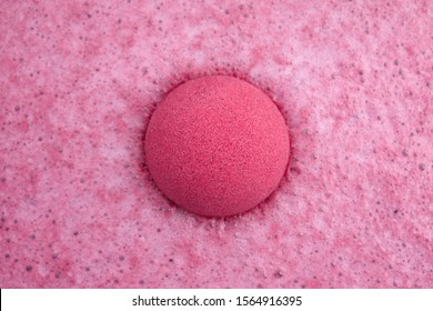 Pink Bath Bomb Foaming In Water, Close Up View