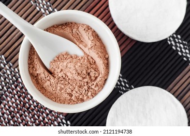 Pink Bentonite Clay Powder In The Small White Bowl And Cotton Pads. Clay Texture Close Up. Diy Facial Or Hair Mask, Dry Shampoo Recipe. Natural Beauty Treatment And Spa. Top View, Copy Space