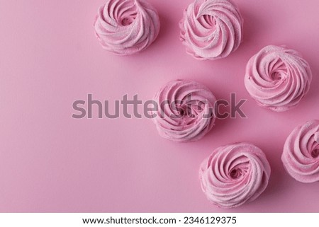 Pink berry homemade marshmallow. Zefir dessert with red currant mousse on the pink pastel background. Flat lay