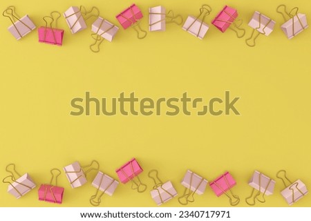 Pink binders lie in a chaotic order on a yellow background. View from above. School concept.
