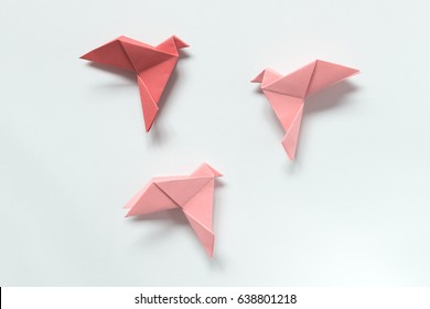 Pink Birds of different shades. Origami on light background. The concept of freedom, inspiration. - Powered by Shutterstock