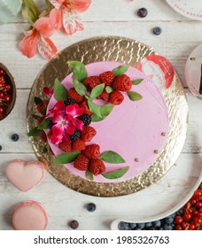 Pink Birthday Cake With Rasberry And Mulberry. Background Decorated With Macarones, Fruits, Flowers And Tea.