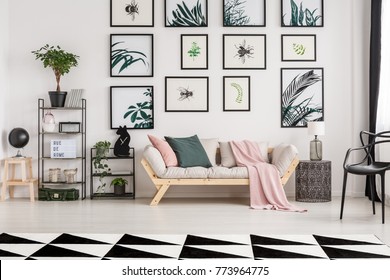 Pink Blanket And Green Pillow On Sofa In Botanic Living Room With Geometric Carpet And Metal Furniture