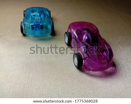 pink and blue colored toy car 
