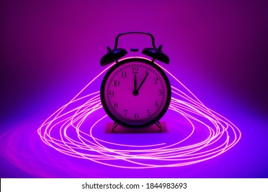Pink and blue concept clock in laser rings.